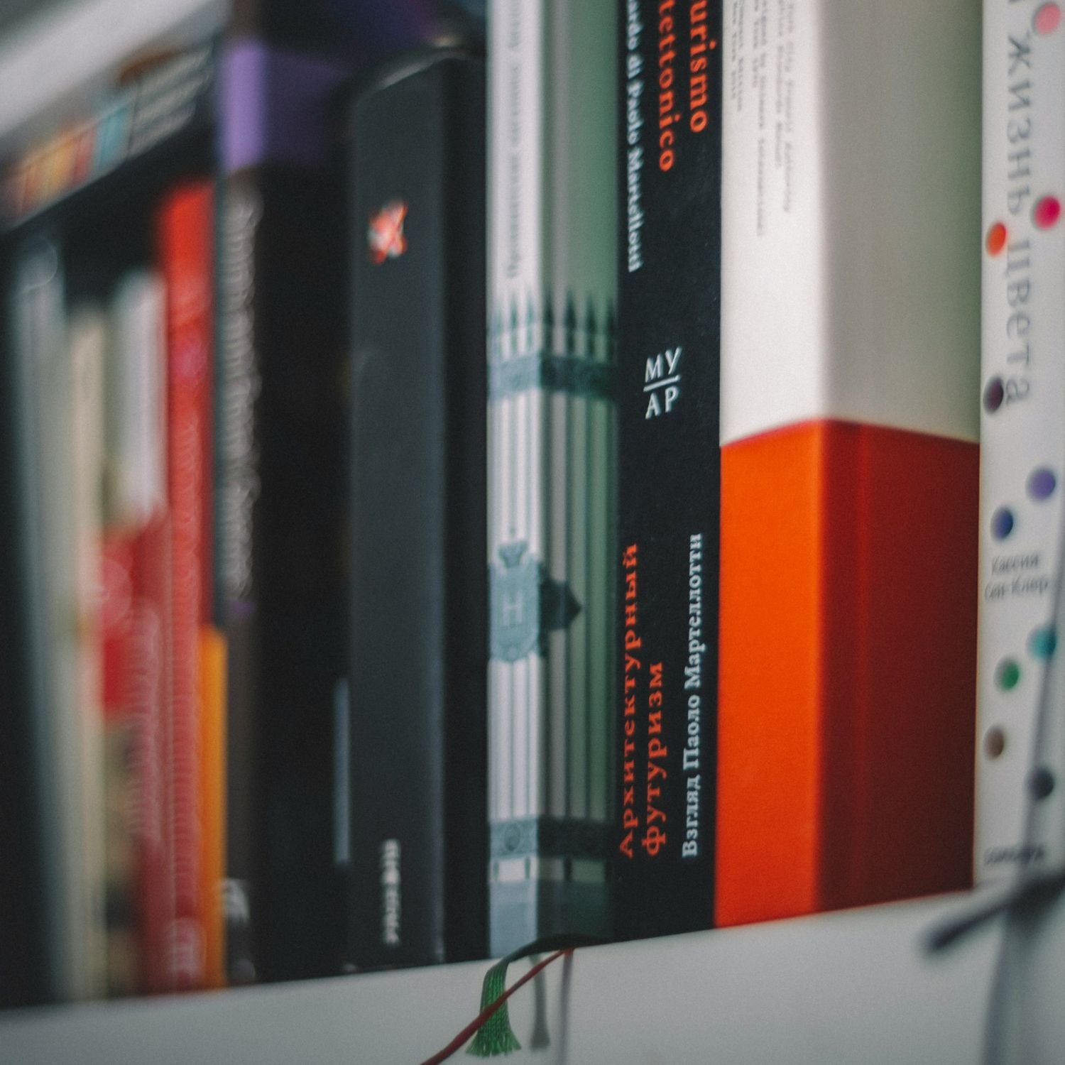 Stack of books with various covers on a shelf