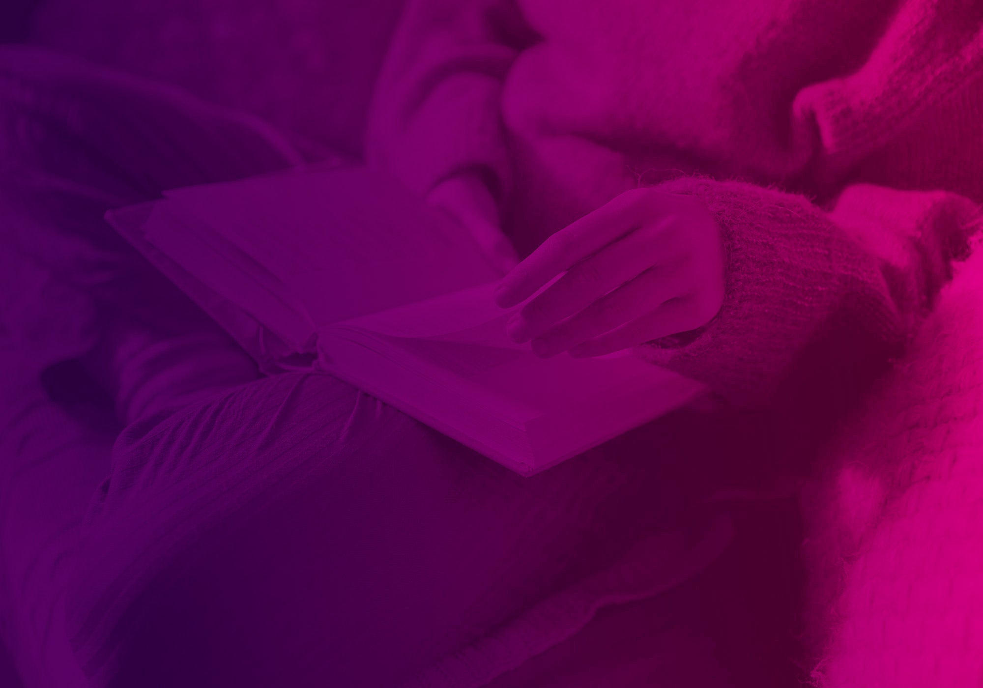 A cozy close-up of a person wrapped in a soft blanket, holding an open book. The entire scene is heavily tinted with a vivid magenta and purple color overlay.